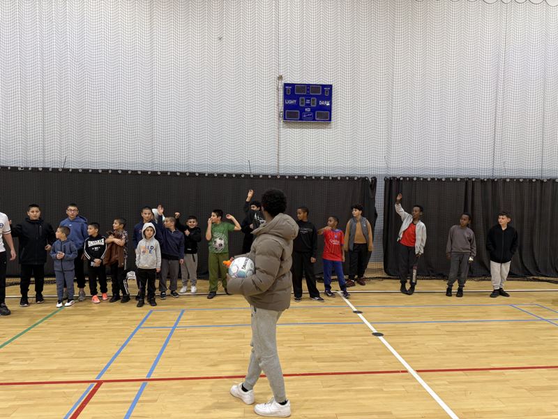The indoor court before kick-off, boys waiting along the far wall